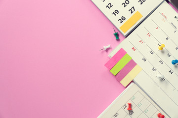 close up of calendar on the pink table background, planning for business meeting or travel planning concept