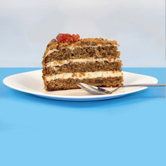 A piece of cake with cream on a white plate