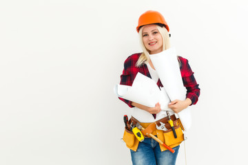 Attractive blonde business woman working as an architect on a building construction site
