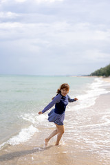 Fototapeta na wymiar Middle age senior woman is Enjoying and running Summer Vacation on the beach, Thailand.