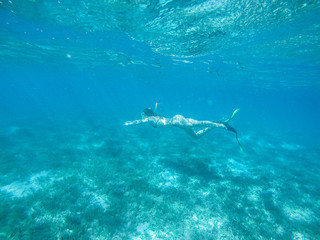 Diving in the red sea. Sexy girl in bikini and mask. Snorkeling. Traveling lifestyle. Water sports. Beach holidays.