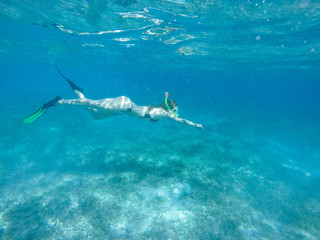 Diving in the red sea. Sexy girl in bikini and mask. Snorkeling. Traveling lifestyle. Water sports. Beach holidays.