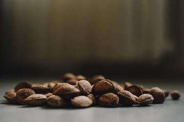 Inshell almonds on wooden background