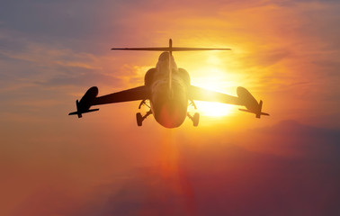 Night flight. Military Airplane in the sky at sunset