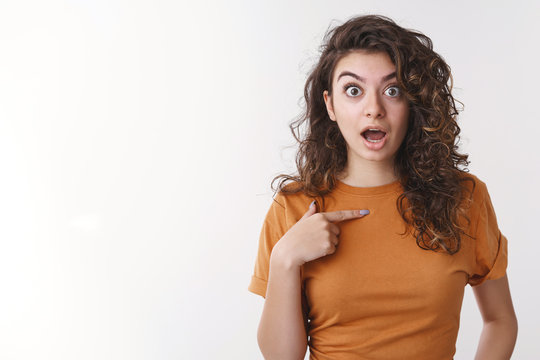 Shocked girl being surprised she picked chosen unwilling participate pointing herself widen eyes disturbed worried open mouth displeased, arguing not want involved, standing white background