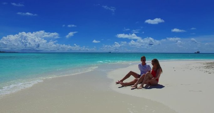two people sitting and talking in seashore of barbados