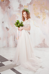 Plakat Portrait of a young beautiful woman in wedding dress with wreath and bouquet of fresh flowers.