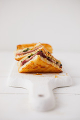 Baked spinach and ham sandwich with sauce.