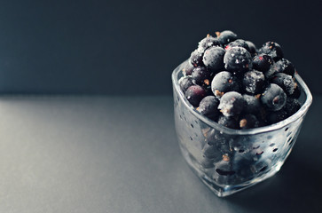 frozen blackcurrant close up on dark background