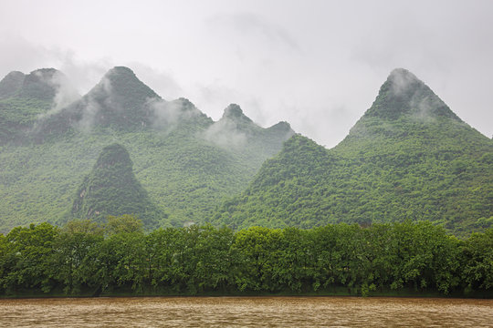 Passing misty hills near the Mopanshan wharf navigating on the Li River near Guilin