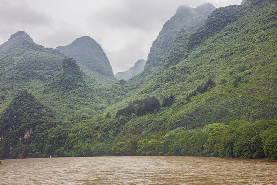 Passing misty hills with deep valleys on the Li River near Guilin
