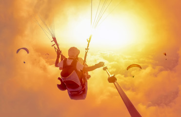 Extreme sport. Landscape .Paragliding in the sky. Paraglider tandem flying over the sea with blue...