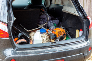 tools and equipment in the trunk of a car. work in the country or in the village.