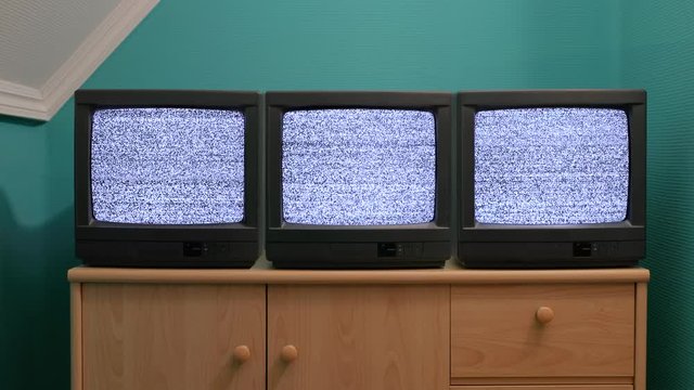 No signal noise on three old TV sets right next to each other in room, loopable footage