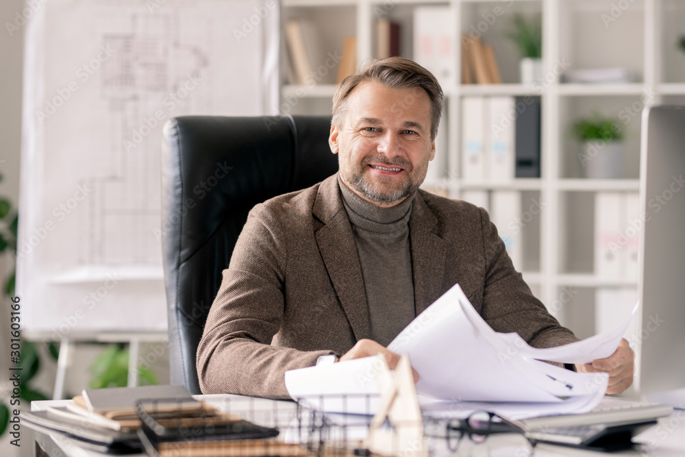 Poster successful mature engineer or architect in formalwear working with papers