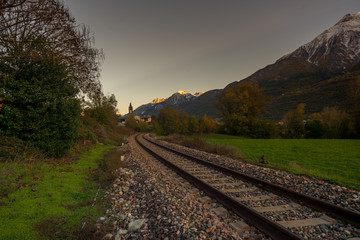 Countryside landscape with mountains in the background at blue hour.