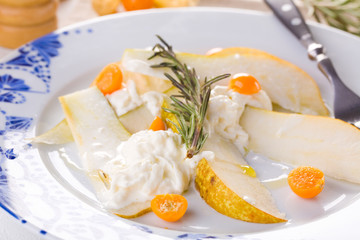 traditional pear and cheese salad on a white plate
