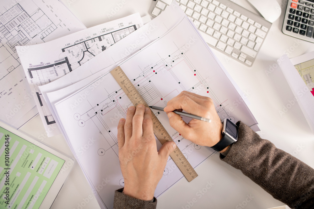 Poster Overview of hands of engineer with pencil and ruler drawing line on sketch