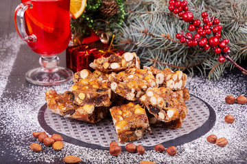 Italian sweet nuts, hazelnuts, almonds, figs, honey dessert over on sugar powder surfase