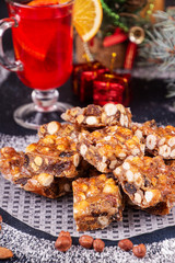 Italian sweet nuts, hazelnuts, almonds, figs, honey dessert over on sugar powder surfase