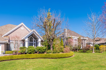 A perfect neighbourhood. Houses in suburb at Summer in the north America. Luxury houses with nice landscape.