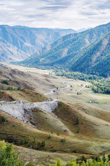 Fototapeta na wymiar Serpentine mountain road. View of the Chuysky tract from the Chike-Taman pass, Altai mountains, Russia