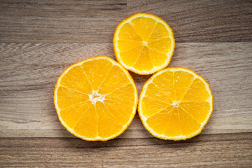 Fototapeta na wymiar orange slice on a brown wooden background