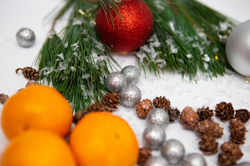 Fir branch and artificial snow along with Toys on white background. New Year and Christmas background.