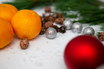 Fir branch and artificial snow along with Toys on white background. New Year and Christmas background.