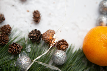 Fir branch and artificial snow along with Toys on white background. New Year and Christmas background.