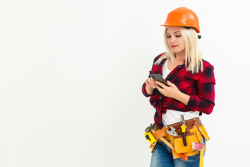 Portrait smiling young engineer woman wearing Yellow Safety helmet standing with mobile phone copy space isolated on white background studio