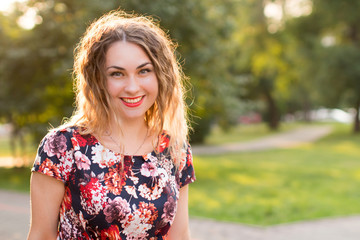 Happy woman laughing hotly on a city street. Close-up attractive caucasian woman with curly hair.