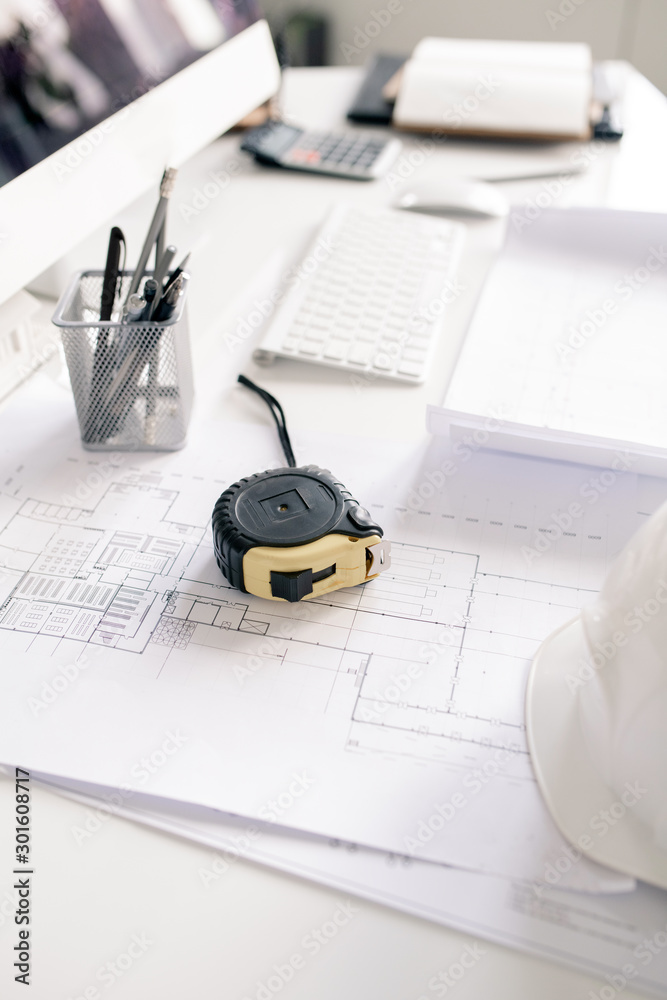 Aufkleber Measuring tape, pencils and blueprints with sketches on workplace of engineer