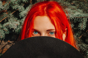 Sexy beautiful redhead girl with long hair. Perfect woman portrait on a background of yellow...