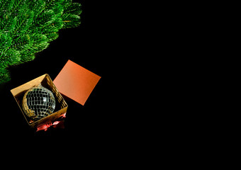 Christmas toy in a box. Christmas tree. Black background. Space for text.