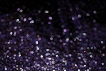Purple bokeh highlightsfading to dark, defocussed sequins