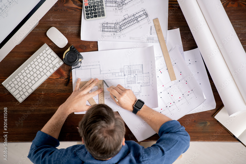 Poster Overview of busy engineer with ruler and pencil drawing line on sketch
