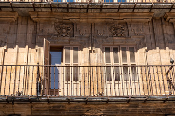Ornate balconies and stone carvings around the windows and doors of apartments in Plaza Mayor in Salamanca