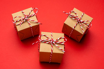 Christmas gifts on a colored red background. New Year, holiday, give, pack.