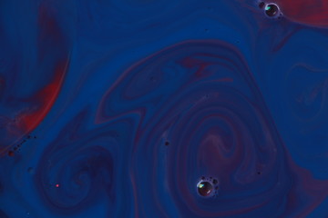 Abstract liquid ink painting texture. Blue and red color swirl marble background. Psychedelic.
