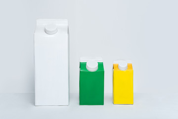 Three carton box or packaging of packaging with a cap on a white background.