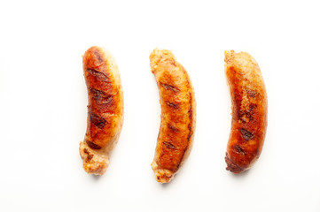 three fried sausages on a white background