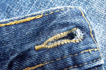 Close up detail of old torn denim jeans zipper