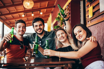 Group of friends having a good time at the bar