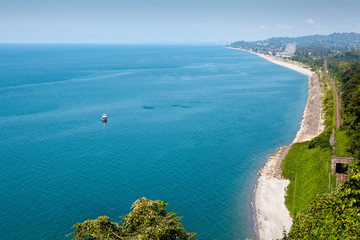 Beautiful summer view of the Black sea from Botanical garden in Batumi, Georgia. Bright landscape with green-blue water and a lot of greenery on the hills