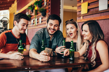 Group of friends having a good time at the bar