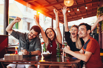 Group of friends having a good time at the bar - Powered by Adobe