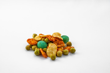 Japanese spicy snacks with peanuts and wasabi lie on a white background