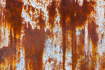 Texture of iron metal painted multicolored red yellow peeling paint of old battered scratched...