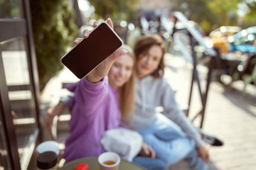 Focused photo on female hand that holding her telephone